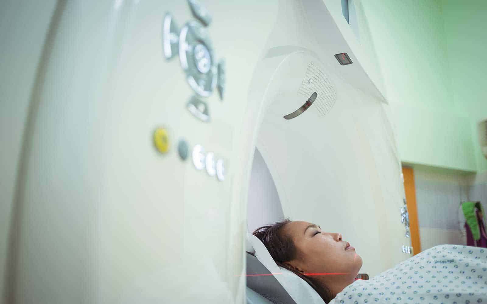 Female patient undergoing CT scan test
